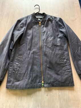 Tunnelus bomber jacket made of navy blue coated denim with a gold full zip